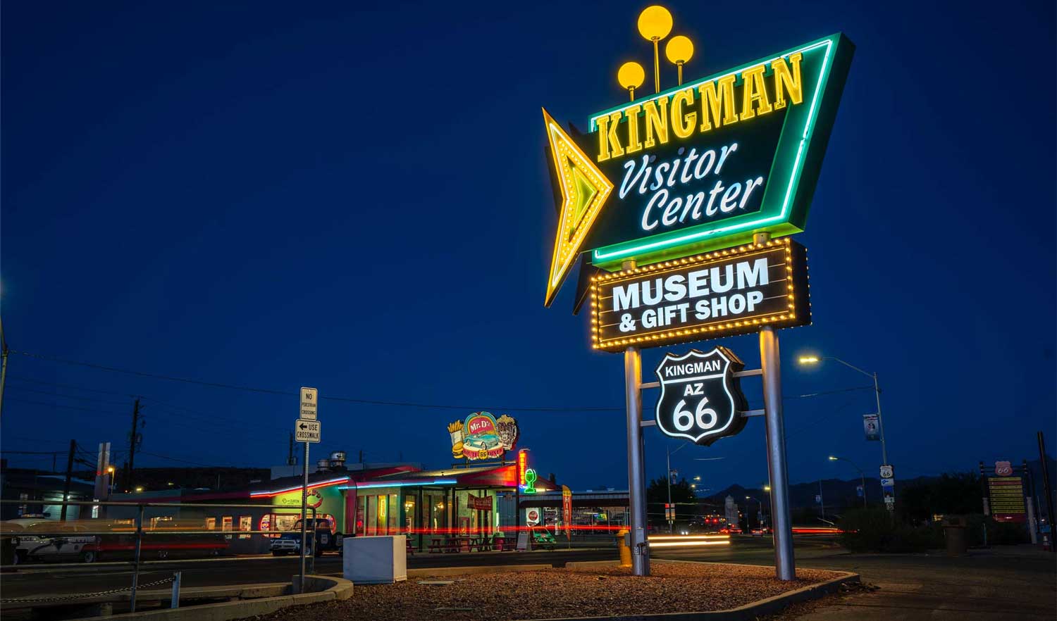 kingman visitor center and neon sign at dusk