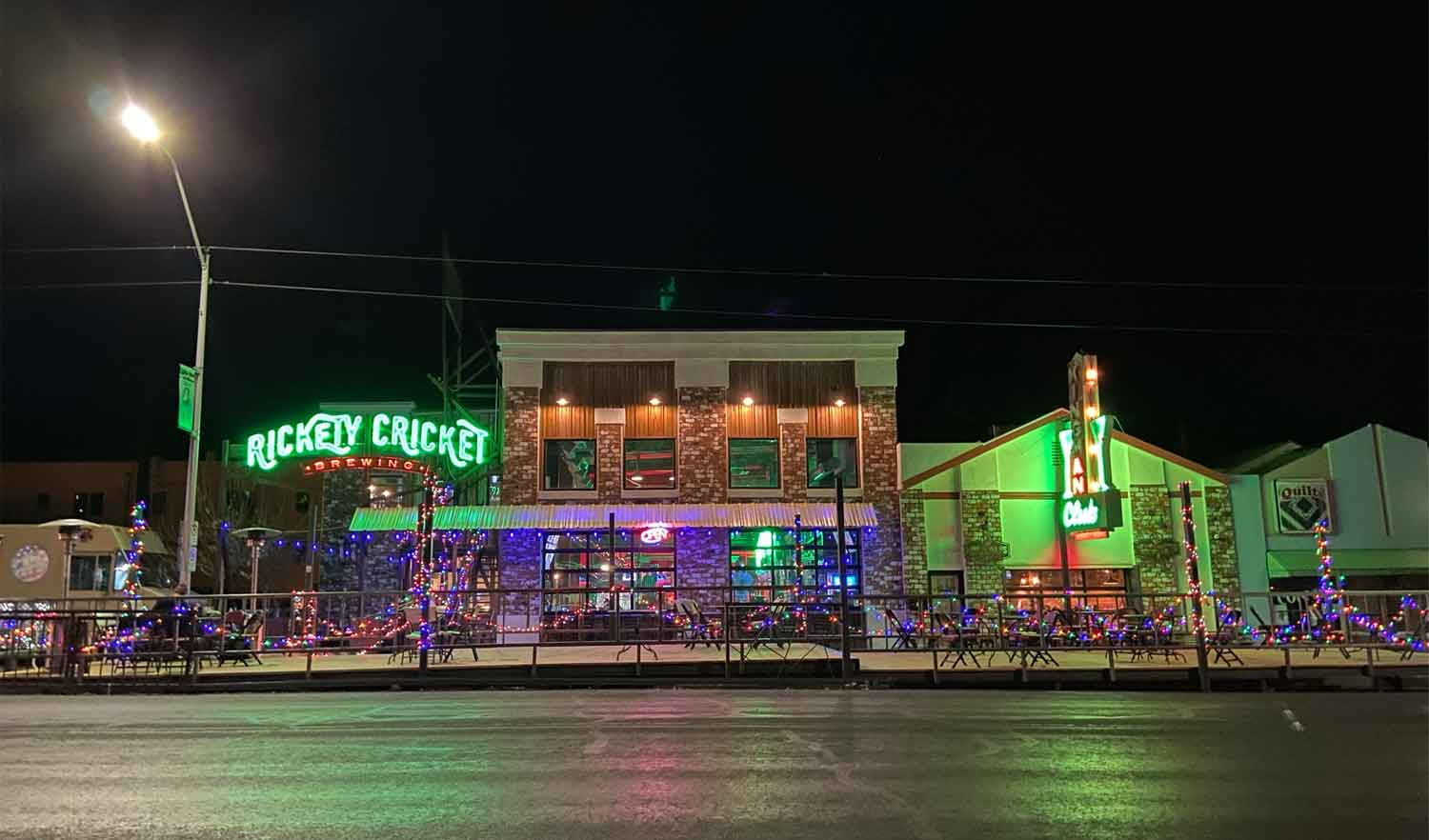 businesses at night with neon signs