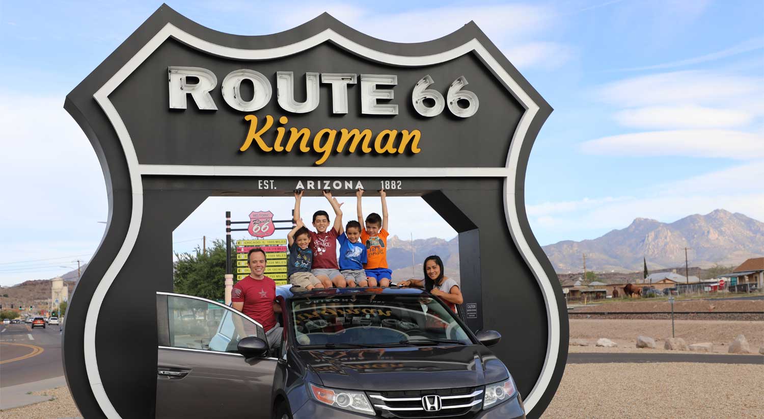 Family in front of Route 66 sign in Kingman, AZ